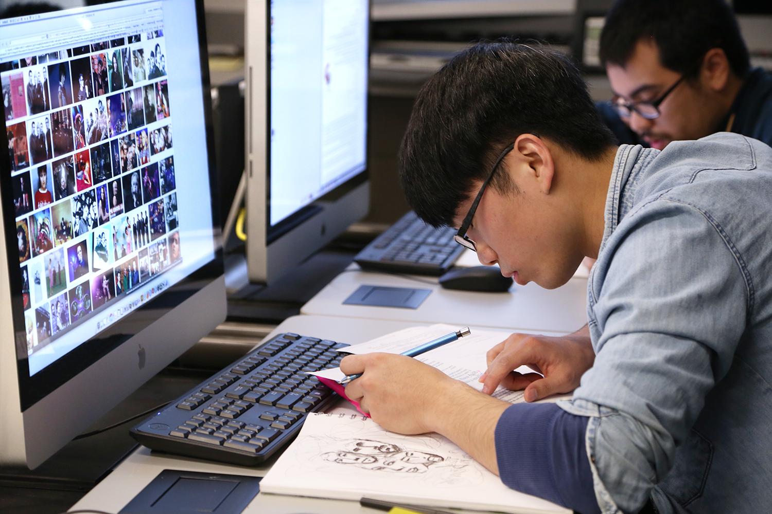 Students work in a graphic design class.